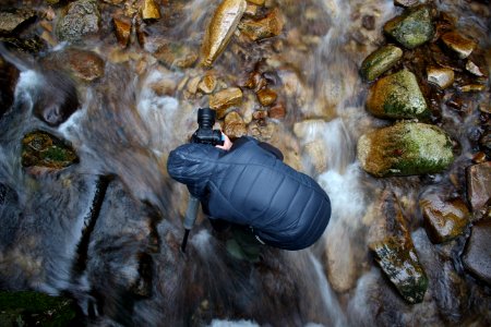 man standing on stream photo