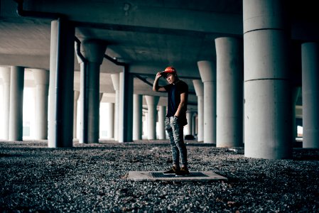 man standing on gray concrete floor photo