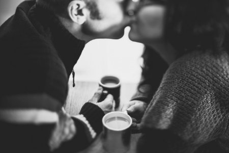 grayscale photography of a man kissing a woman photo