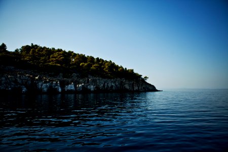 body of water near mountain photo