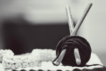 gray wooden sticks with black yarn photo