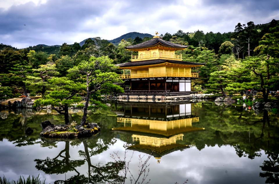 black and brown 3-layer gazebo in middle of water