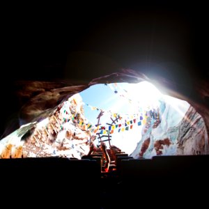 person riding roller coaster entering a hole