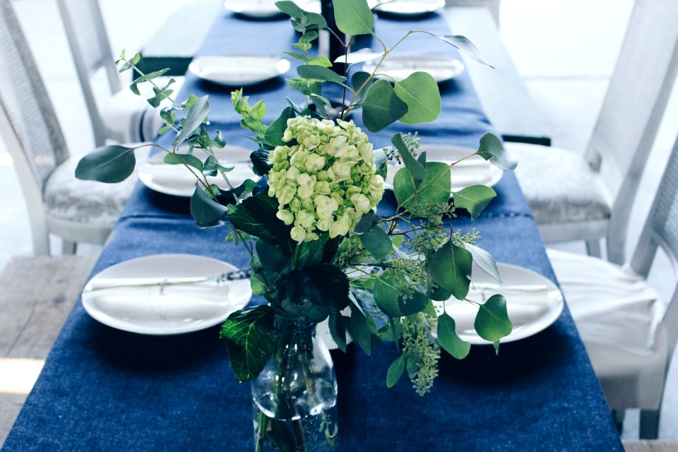 green and white flower centerpiece on table