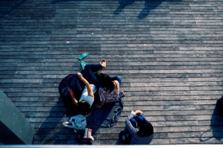 person laying on wooden flooring photo