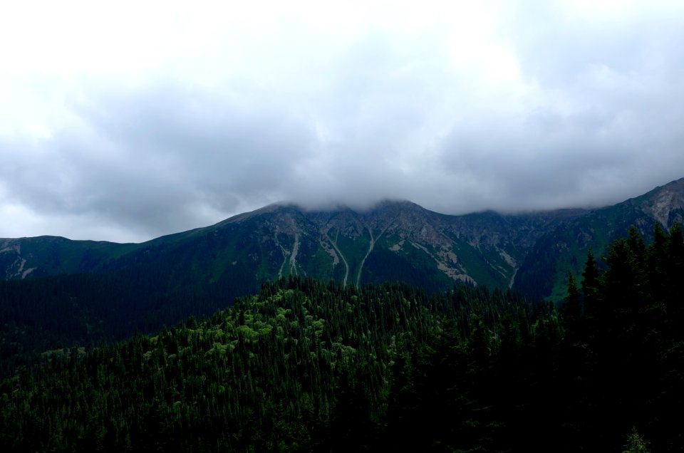 mountains under cloudy skies at daytime photo