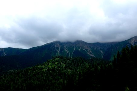 mountains under cloudy skies at daytime