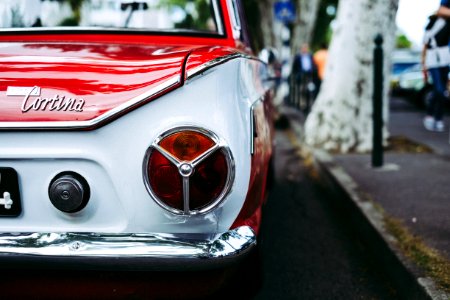 red and white Cortina car parked beside tree photo