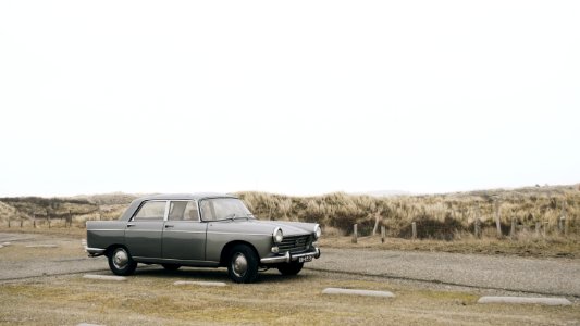 gray sedan parked on roadside during daytime