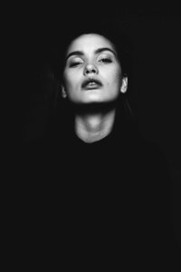 black and white photo of woman looking upward