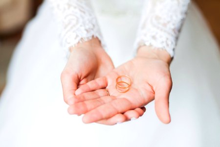 person holding copper rings during daytime