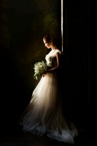 woman wearing wedding gown white holding bouquet photo