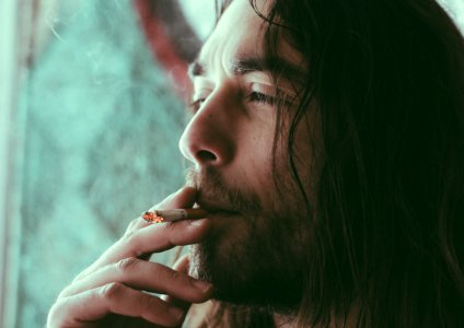 man smoking red cigarette photo