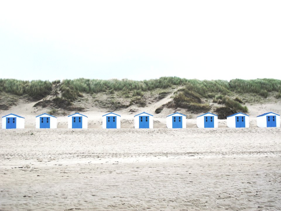 white and blue cabins in the middle of the desert