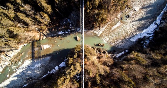 aerial photography of bridge over cliff with body of water at daytime photo