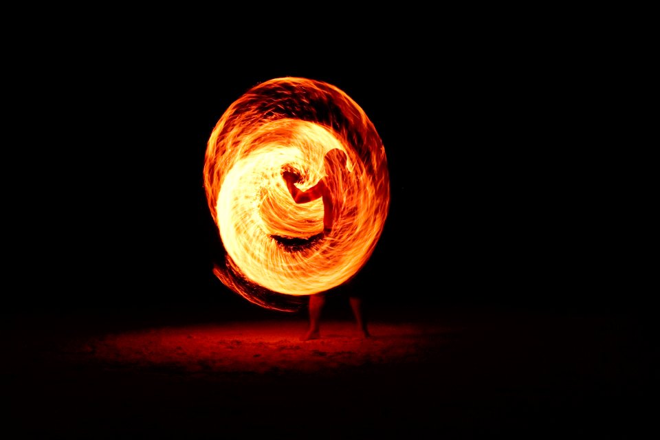 timelapse photography of person fire dancing