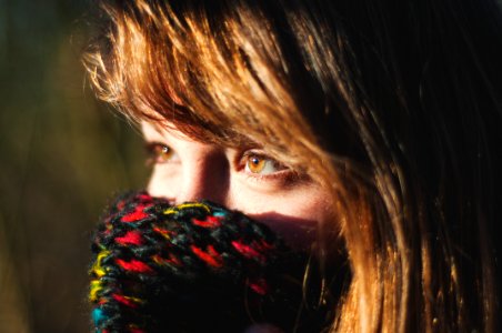 woman covering her multicolored knit mask photo