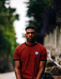 man wearing red and black striped ringer shirt photo