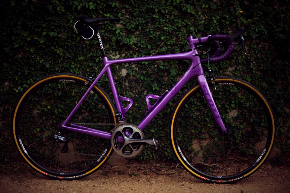 purple road bike near wall