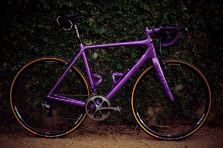 purple road bike near wall
