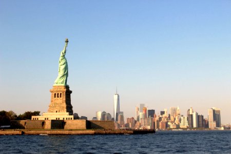 person taking photo of Statue of Liberty