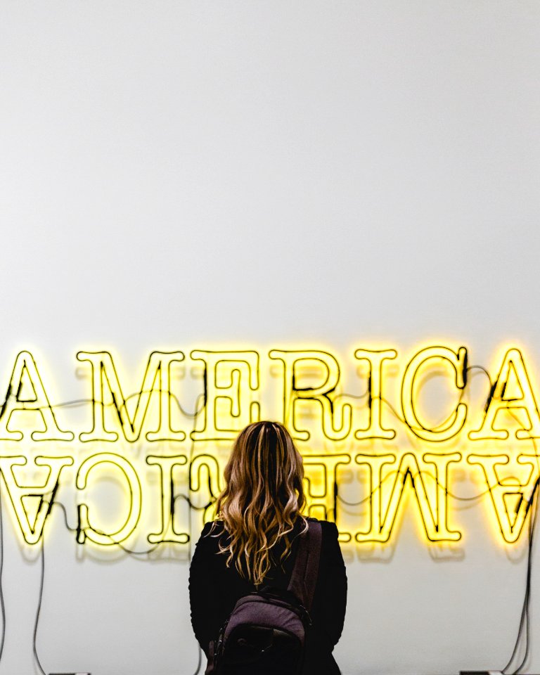 woman in front American lighted signage