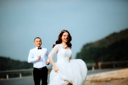 man chasing woman during daytime photo