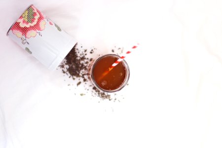 brown liquid with red and white straw photo