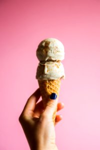 person holding ice cream on cone photo