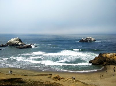 people standing on shoreline photo