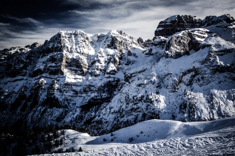 snow capped mountain under gray skies photo