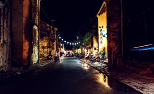 street beside village with lights during night time photo