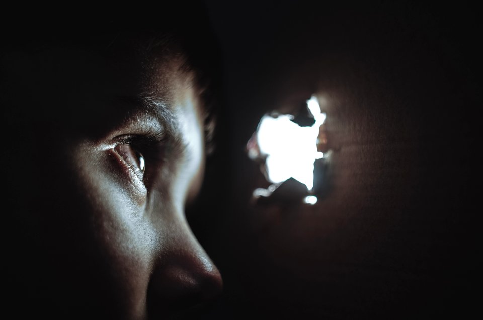 person watching through hole