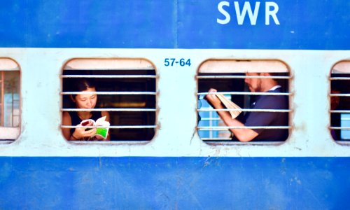 man and woman sitting on train photo
