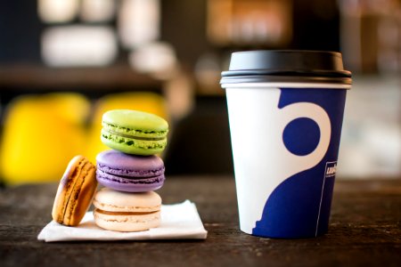 macaroons on tissue beside coffee cup photo