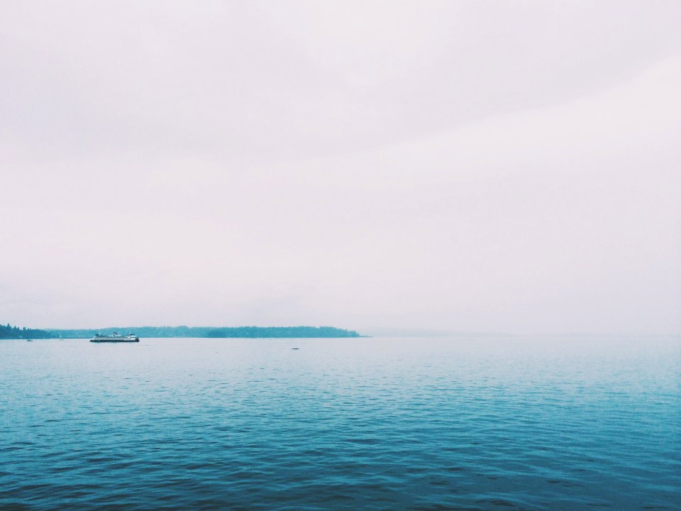 blue sea under gray sky