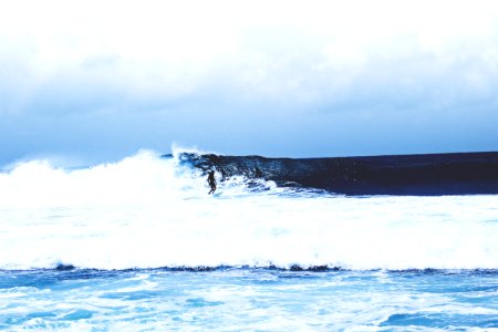 photo of man riding surfboard