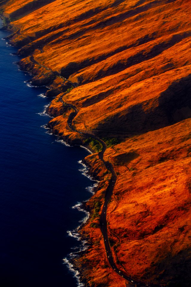 aerial photography of road on mountain near seashore photo