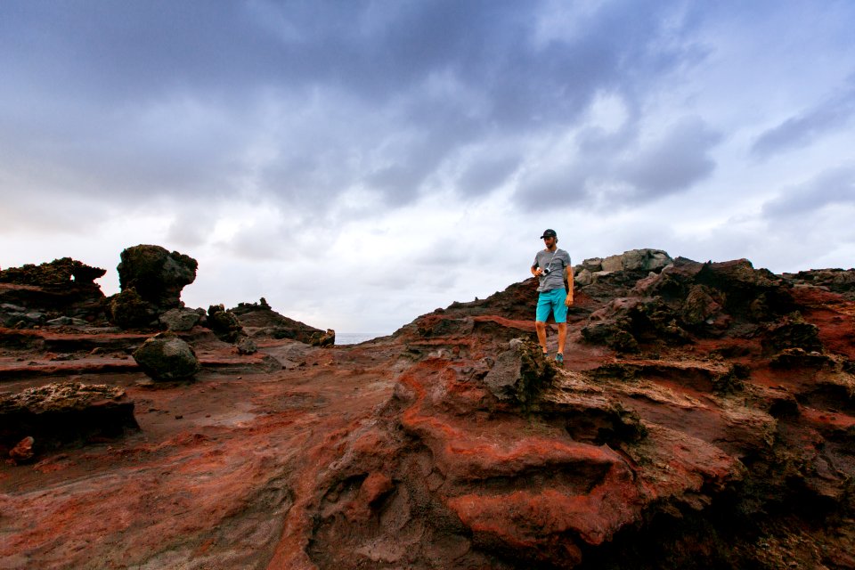 person standing on top on boulder