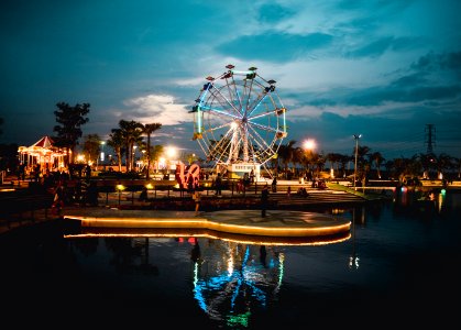 calm body of water near ferris wheel