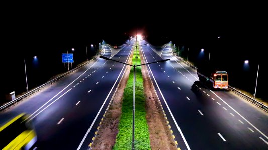 vehicles traveling on roads at night photo