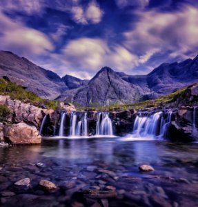 waterfalls under cloudy sky photo