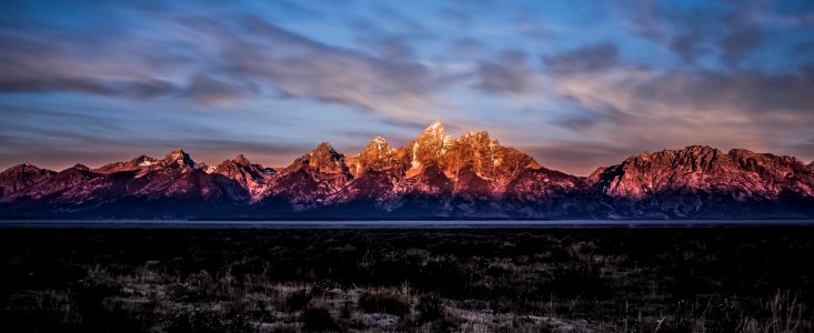 brown rock formations under cloudy sky photo