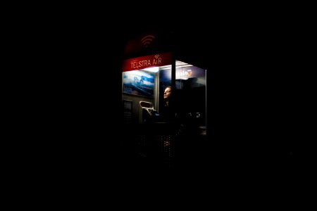 man inside telephone booth photo