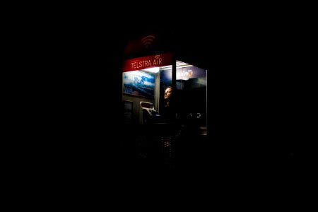 man inside telephone booth