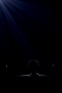 silhouette of person raising two hands