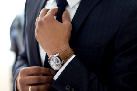 man wearing watch with black suit photo