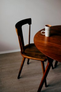 white ceramic mug on brown wooden table photo