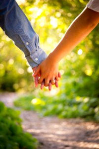 shallow focus photo of man and woman holding hands photo