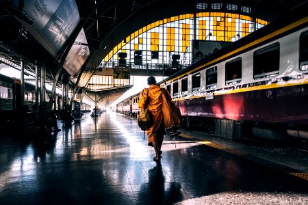 man walking on railway station platform near train